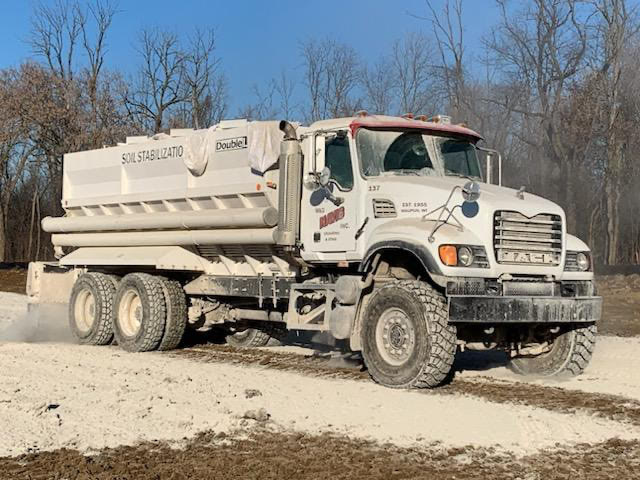 truck spreading soil